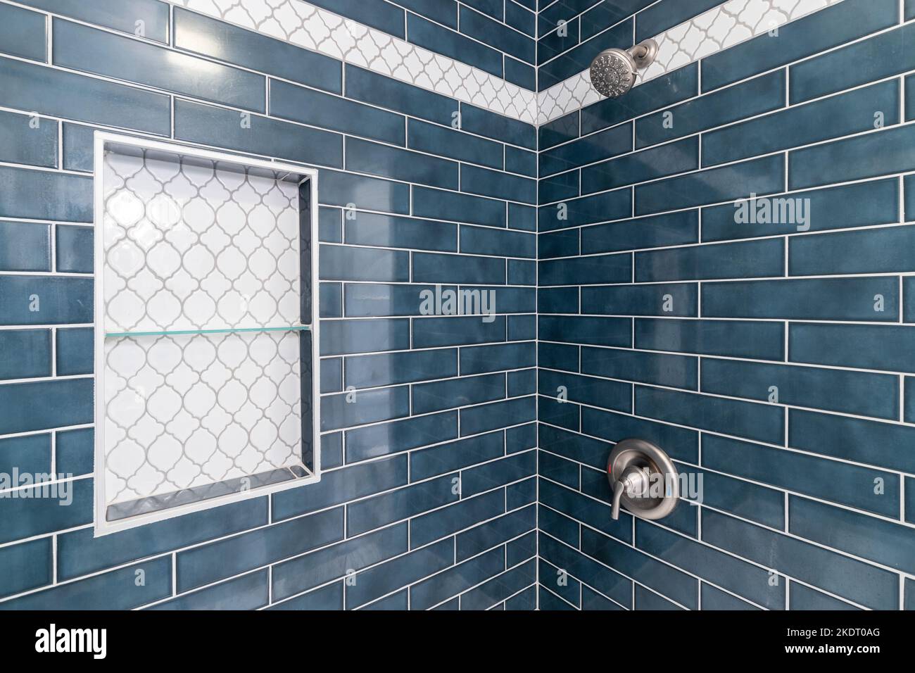 A blue subway tiled shower with a niche inlayed with arabesque shaped tiles  Stock Photo - Alamy, image size:1300x956