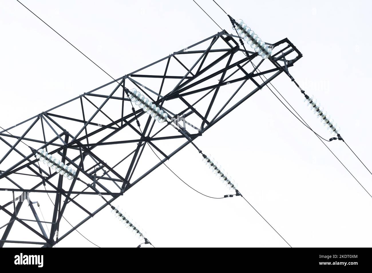 High-voltage power pylon, cables are attached for the transport of large amounts of electrical energy over relatively large distances. On white Stock Photo