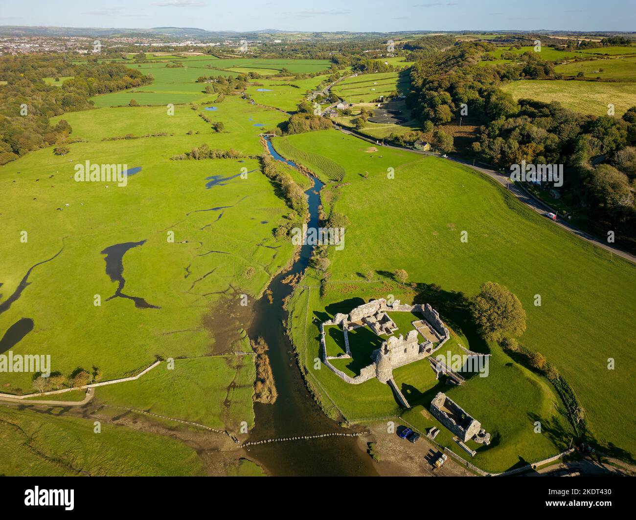 Aerial view of stepping stones over a small river leading to the ruins of an ancient castle (Ogmore Castle, Glamorgan, Wales) Stock Photo