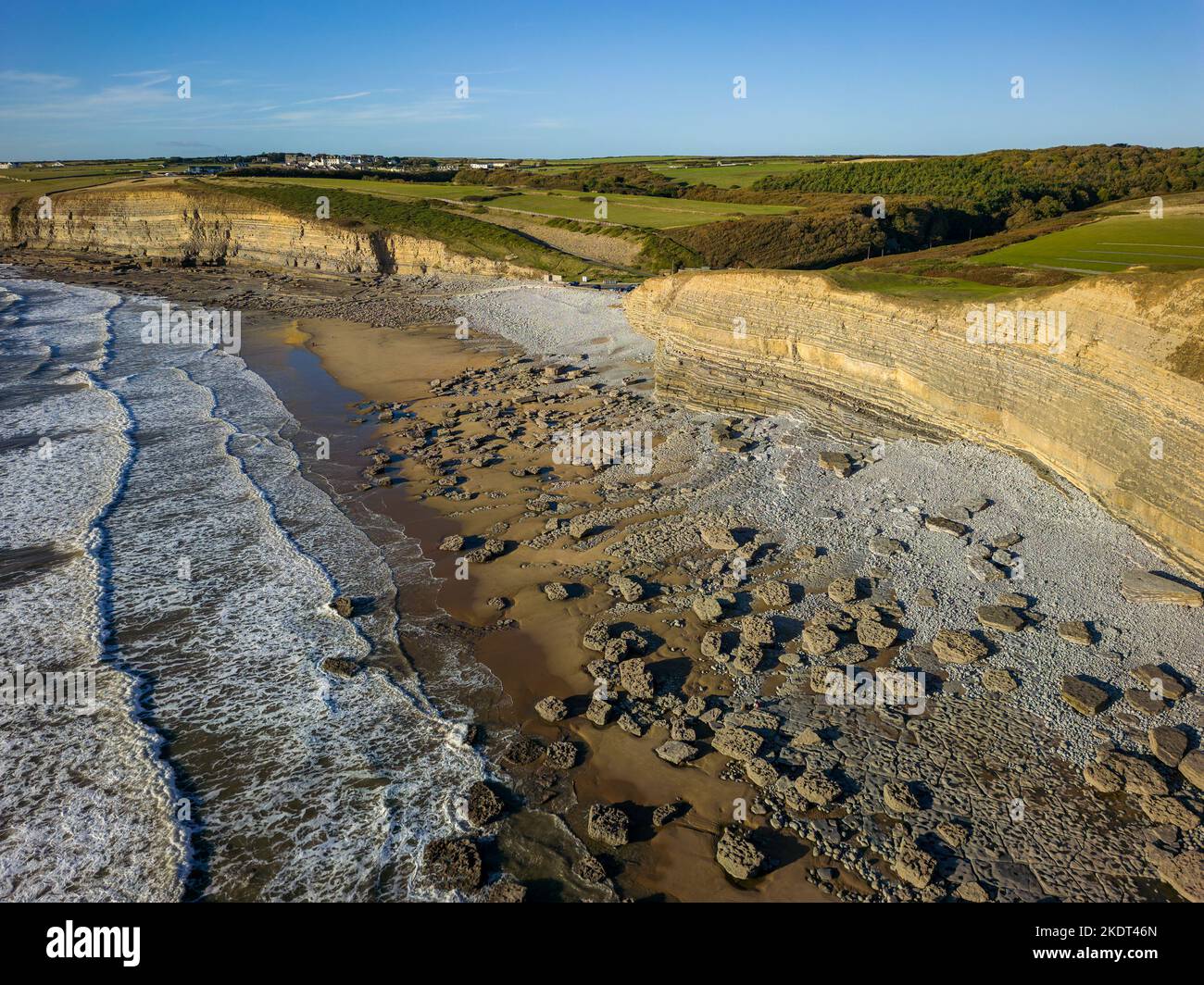 Aerial view of limestone cliffs and a rock covered sandy beach Stock Photo