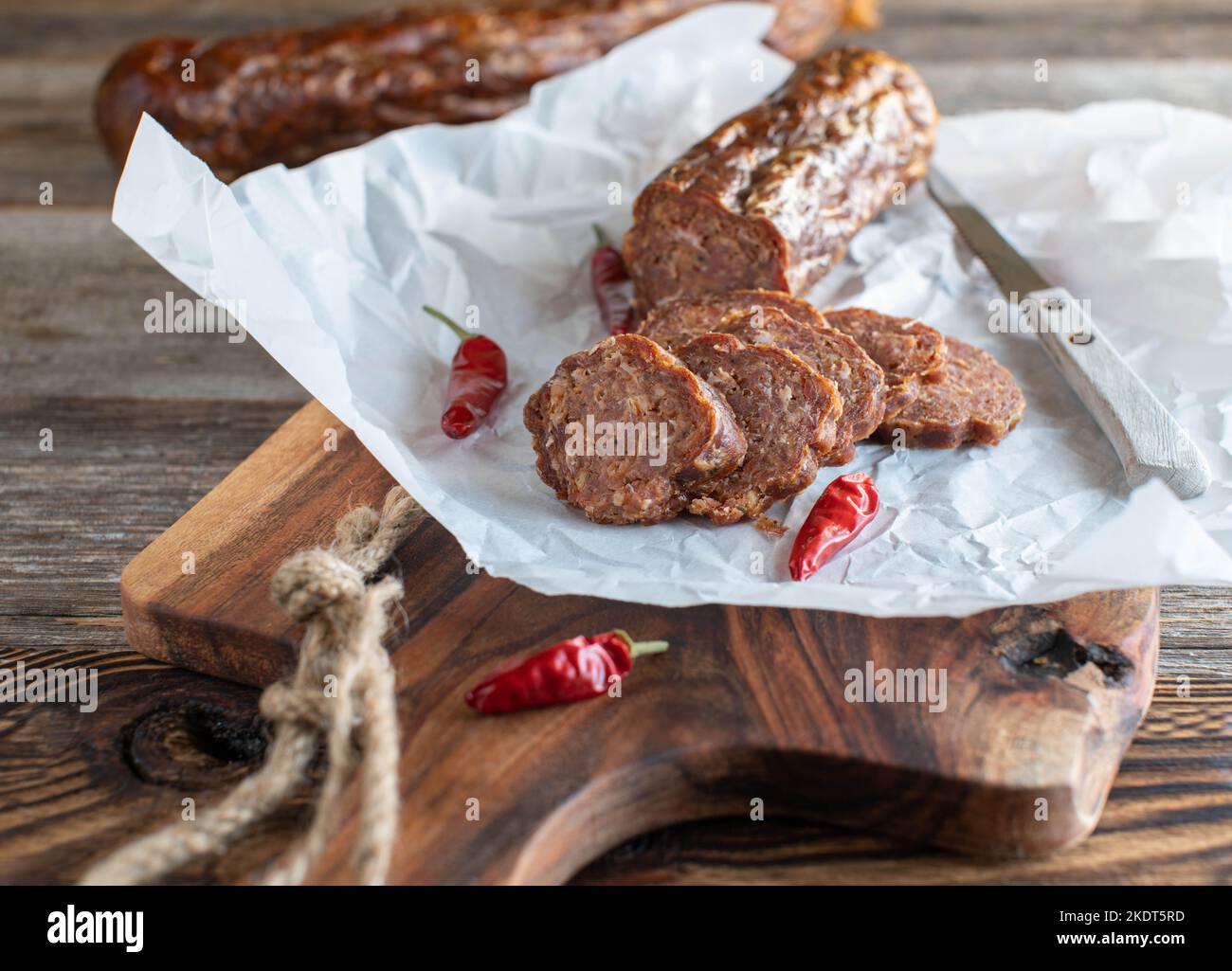 Traditional homemade german salami 'Ahle Wurst' on wooden table Stock Photo
