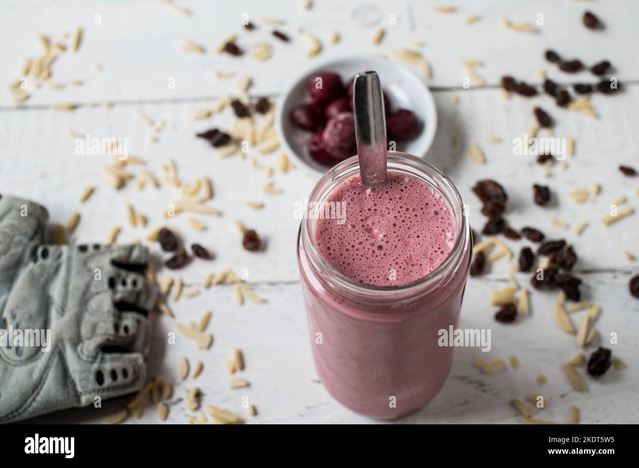 Whey protein shake with sour cherries, almonds and raisins for muscle building workout with fast and complex carbohydrates Stock Photo