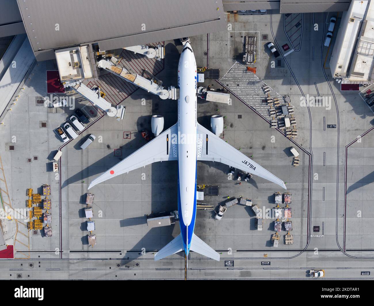 All Nippon Airways Boeing 777 aircraft parked with jet bridge. Airplane 777-300ER of All Nippon, ANA plane top down view at TBIT Terminal LAX. Stock Photo