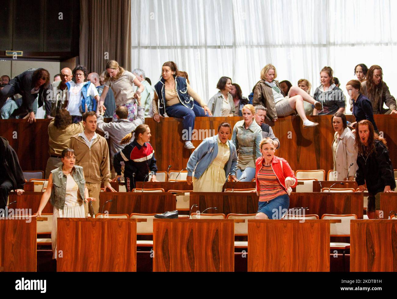 front centre right (in pink): Elizabeth Atherton (A Young Maiden) in MOSES UND ARON by Schoenberg at Welsh National Opera (WNO), Wales Millennium Centre, Cardiff, Wales  24/05/2014  conductor: Lother Koenigs  design: Anna Viebrock  lighting: Tim Mitchell  directors: Jossi Wieler & Sergio Morabito Stock Photo