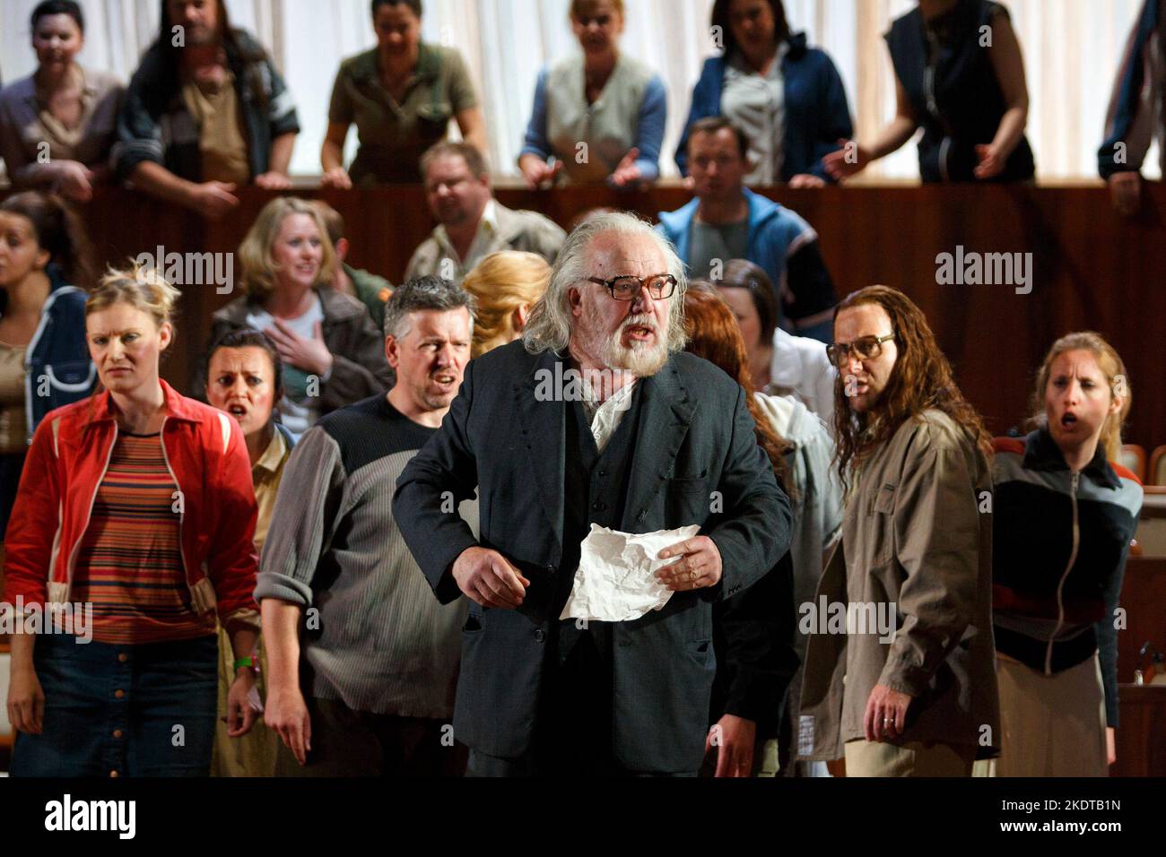 addressing the people: John Tomlinson (Moses) with (front left) Elizabeth Atherton (A Young Maiden) in MOSES UND ARON by Schoenberg at Welsh National Opera (WNO), Wales Millennium Centre, Cardiff, Wales  24/05/2014  conductor: Lother Koenigs  design: Anna Viebrock  lighting: Tim Mitchell  directors: Jossi Wieler & Sergio Morabito Stock Photo