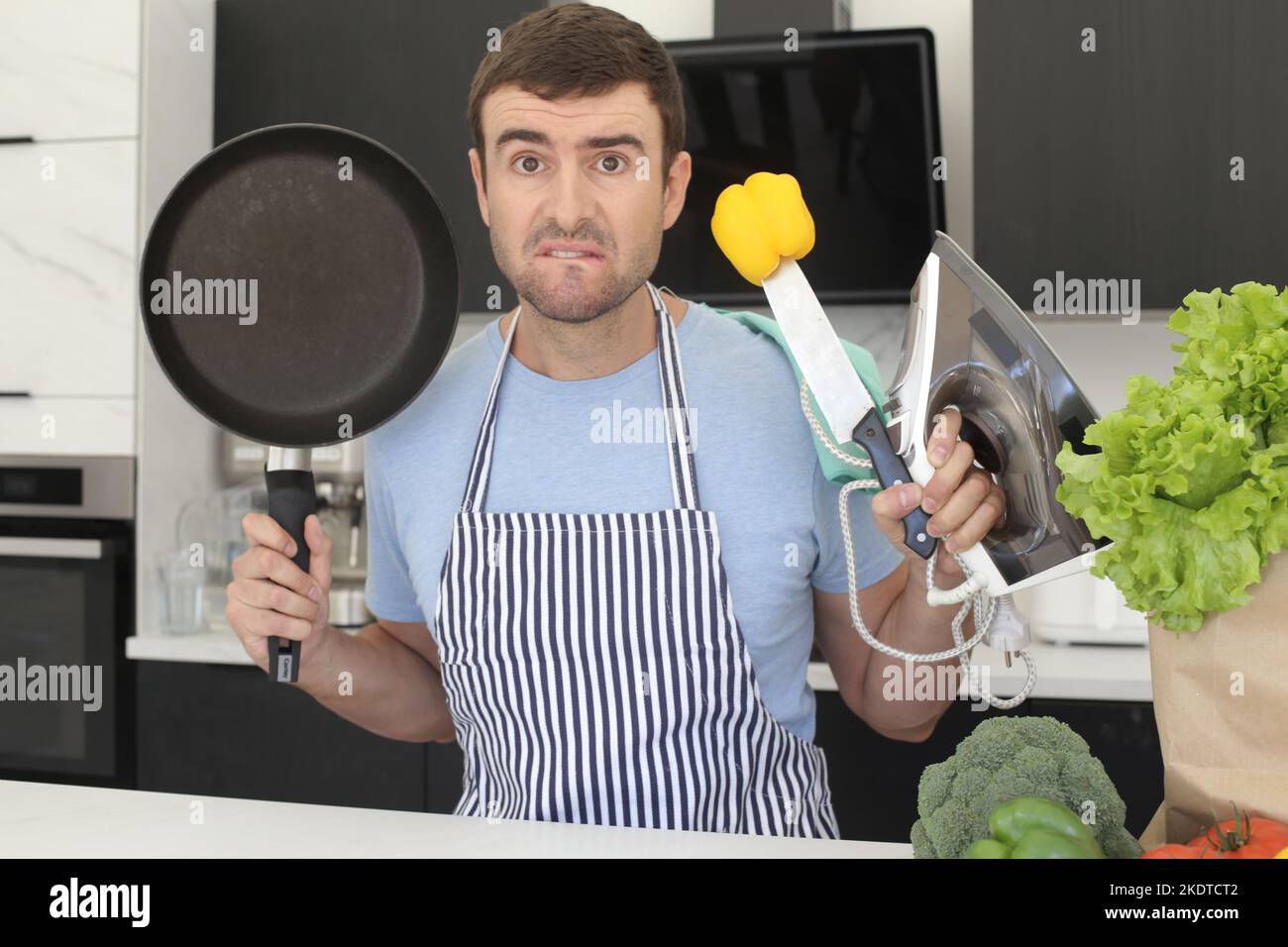 Tired man multitasking at home Stock Photo