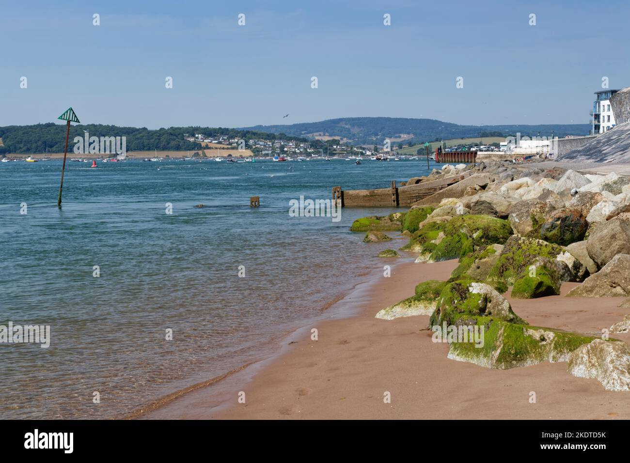 View from Exmouth beach across the Exe Estuary towards Cockwood, Devon, UK, August. Stock Photo