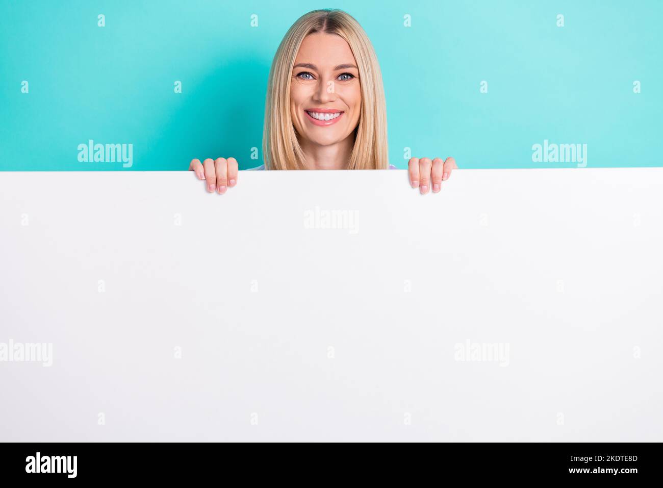Photo of young attractive funny pretty blonde hair woman hold big paper billboard recommendation promo offer isolated on cyan color background Stock Photo - Alamy Photo of young attractive funny pretty blonde hair woman hold big paper billboard recommendation promo offer isolated on cyan color background Stock Photo - Alamy