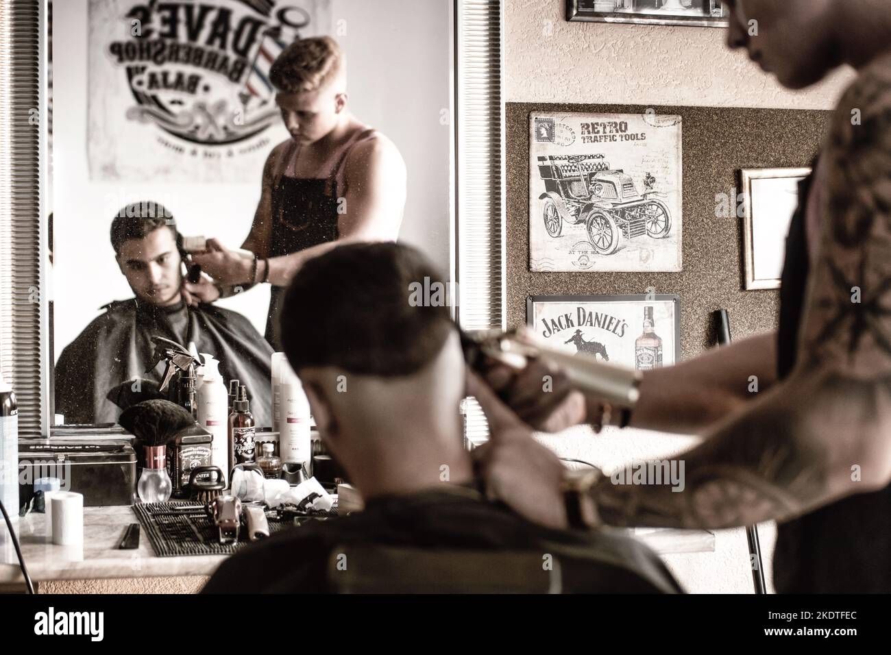 Barber cutting hair in a barber shop in Hungary Stock Photo