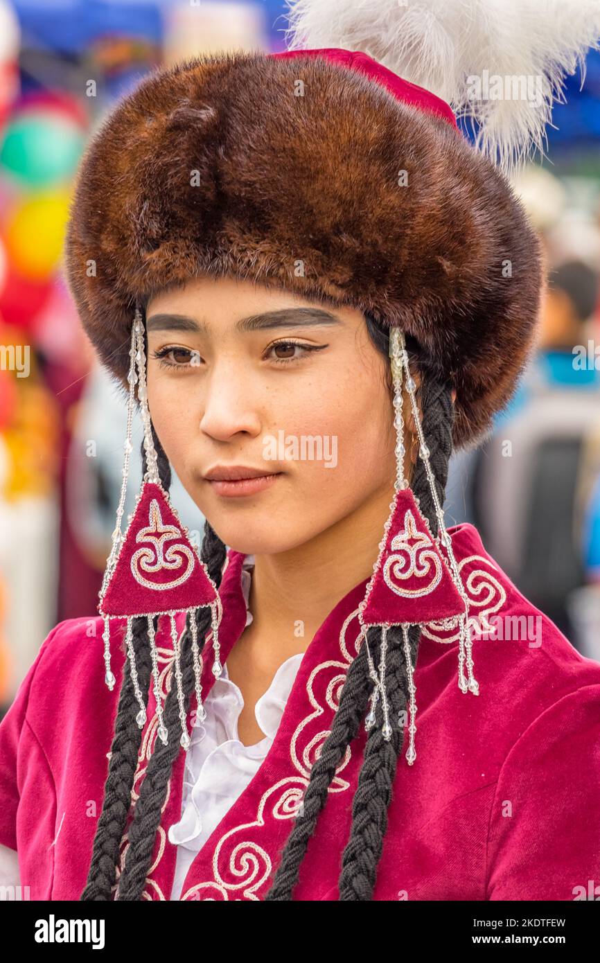 Portrait of of Kyrgyz woman in traditional folk clothing in Osh, Kyrgyzstan Stock Photo