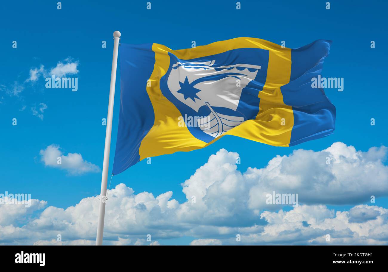 flag of Baltic Finns Saaremaa people at cloudy sky background, panoramic view. flag representing ethnic group or culture, regional authorities. copy s Stock Photo