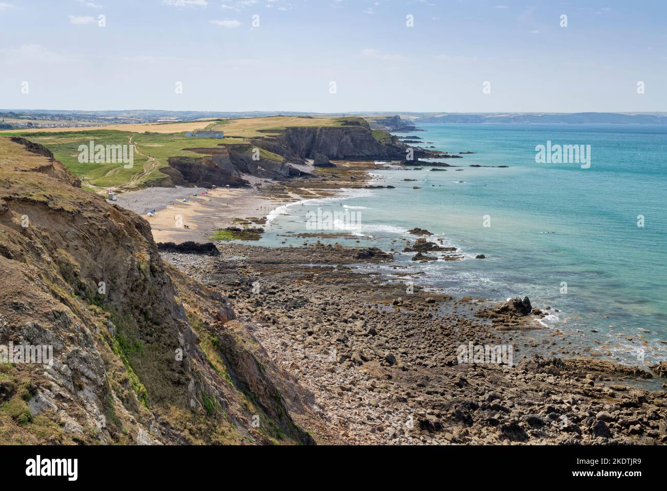 View from the SW coast path at Menachurch Point of Northcott Mouth beach and heavily eroded cliffs looking south towards Bude, north Cornwall, UK July Stock Photo