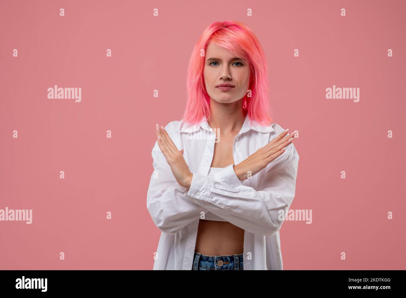 Determined young woman showing a rejection gesture Stock Photo