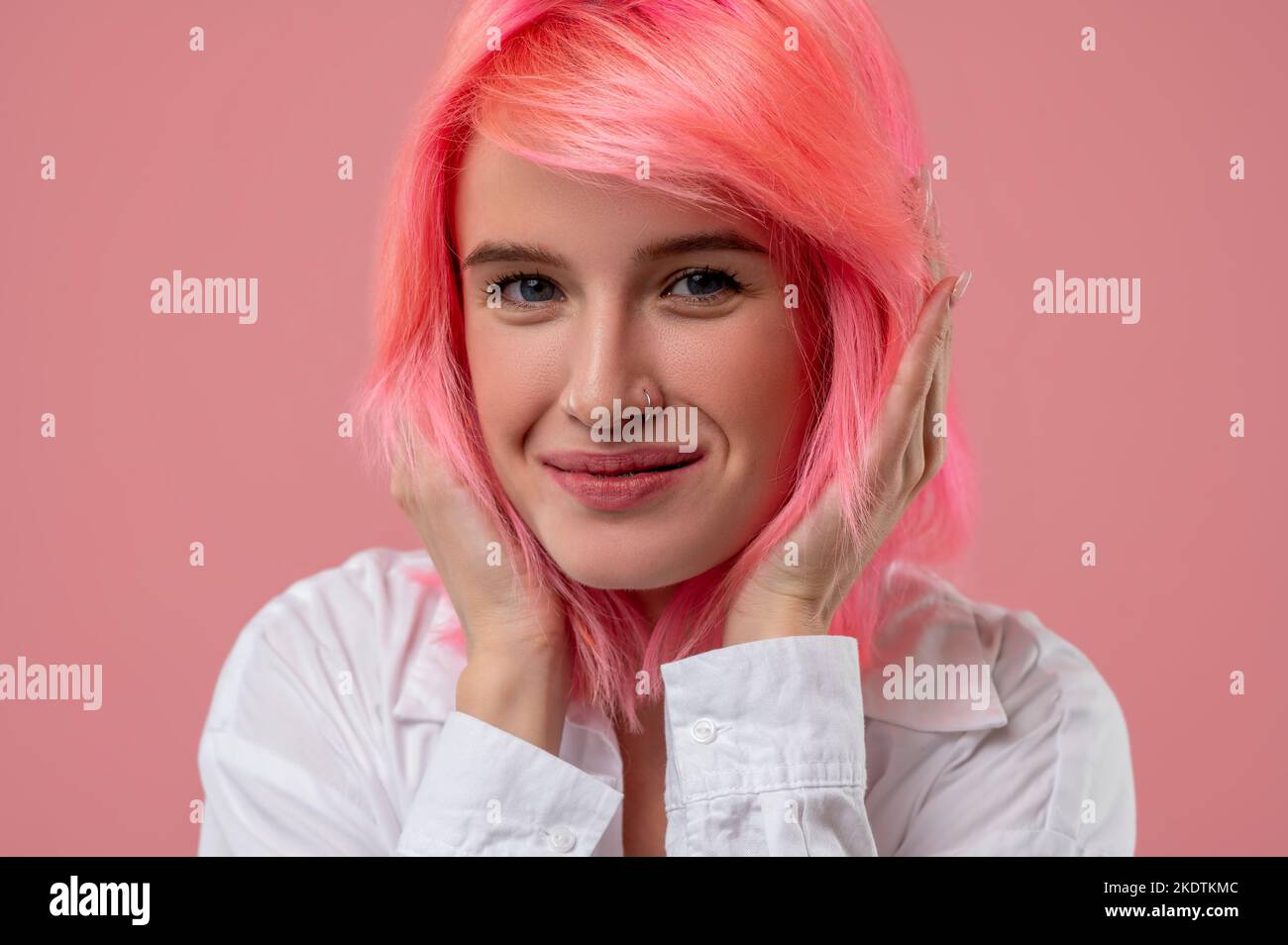 Happy cute pinkhaired girl smiling at the camera Stock Photo Alamy