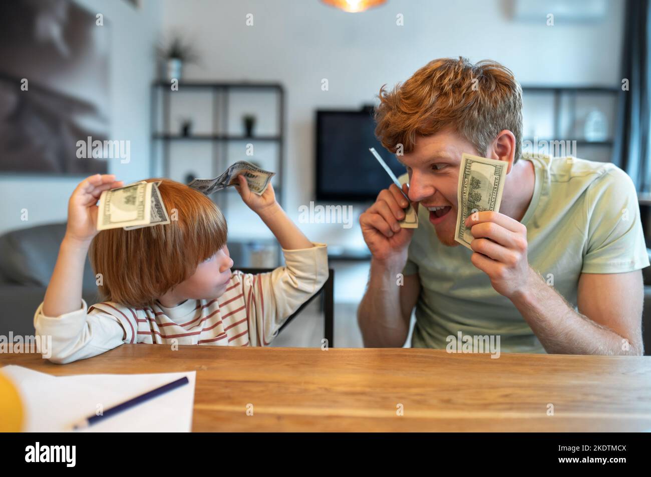 Dad teaching his little son the financial basics Stock Photo