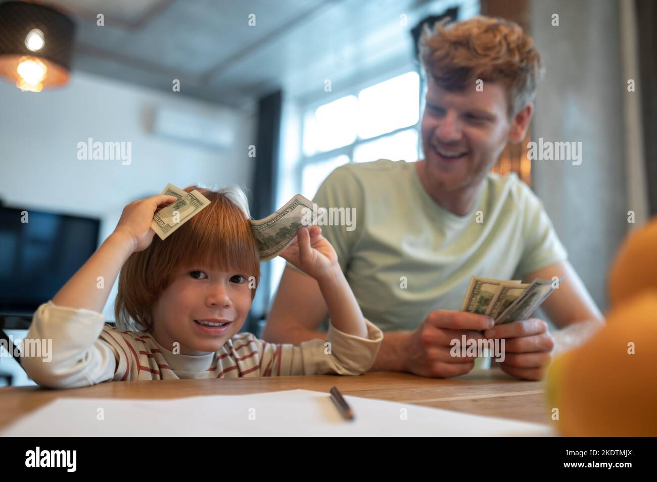 Dad explaining his son the importance of financial literacy Stock Photo