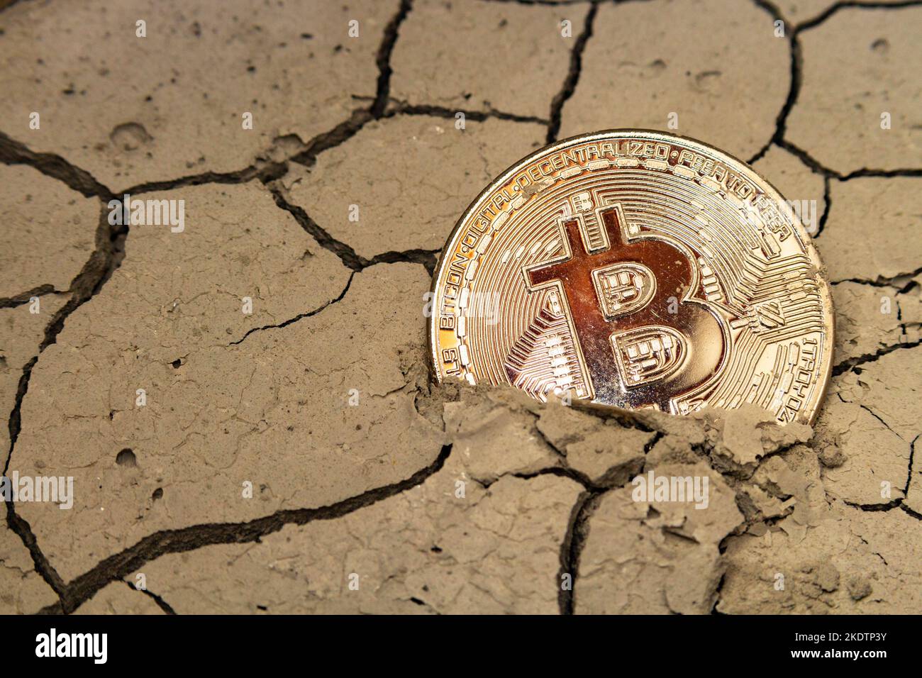 bitcoin lies on desert land, crypto currency crisis concept Stock Photo