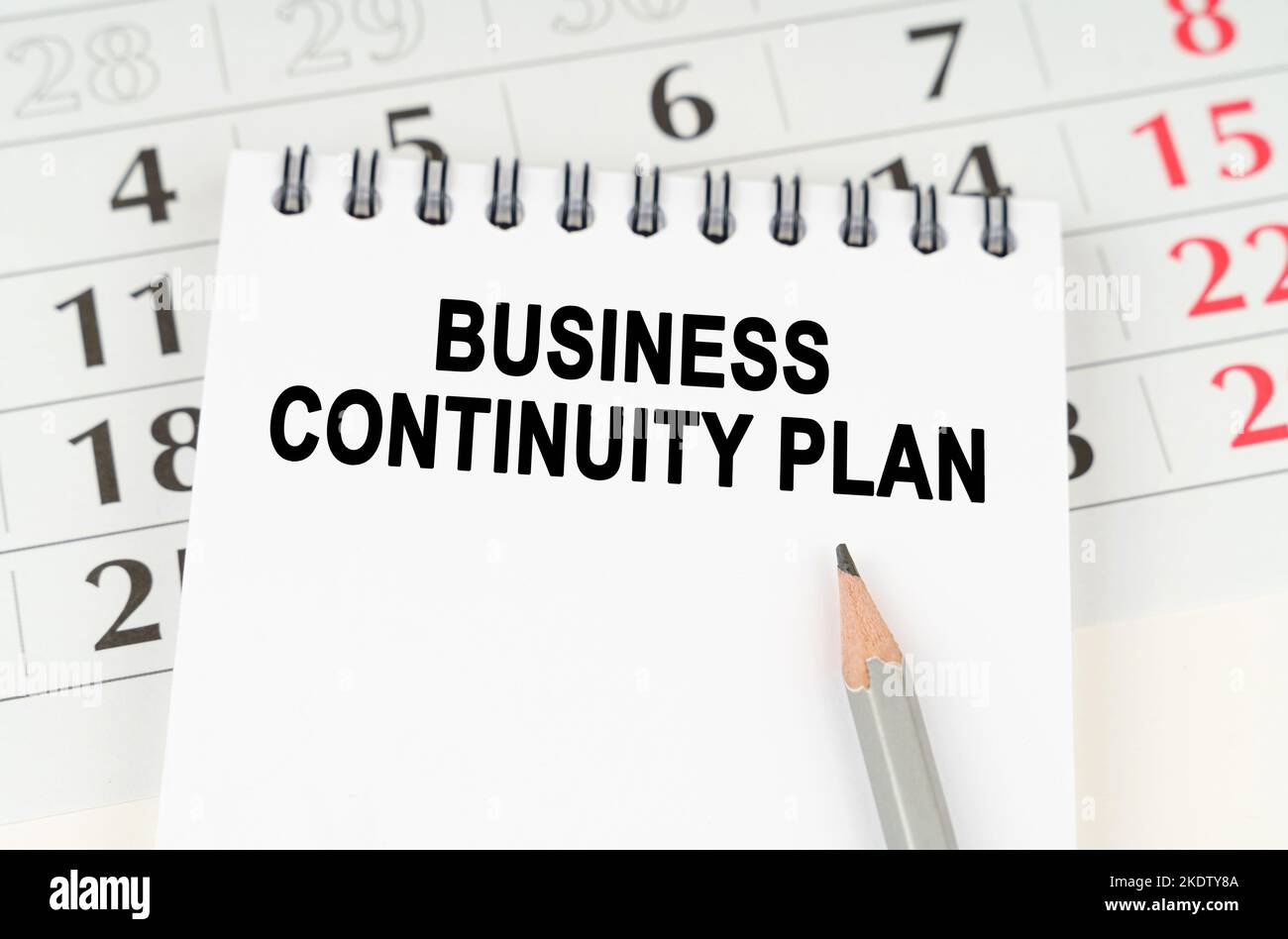 Business planning concept. On the calendar is a notebook with the inscription - BUSINESS CONTINUITY PLAN Stock Photo