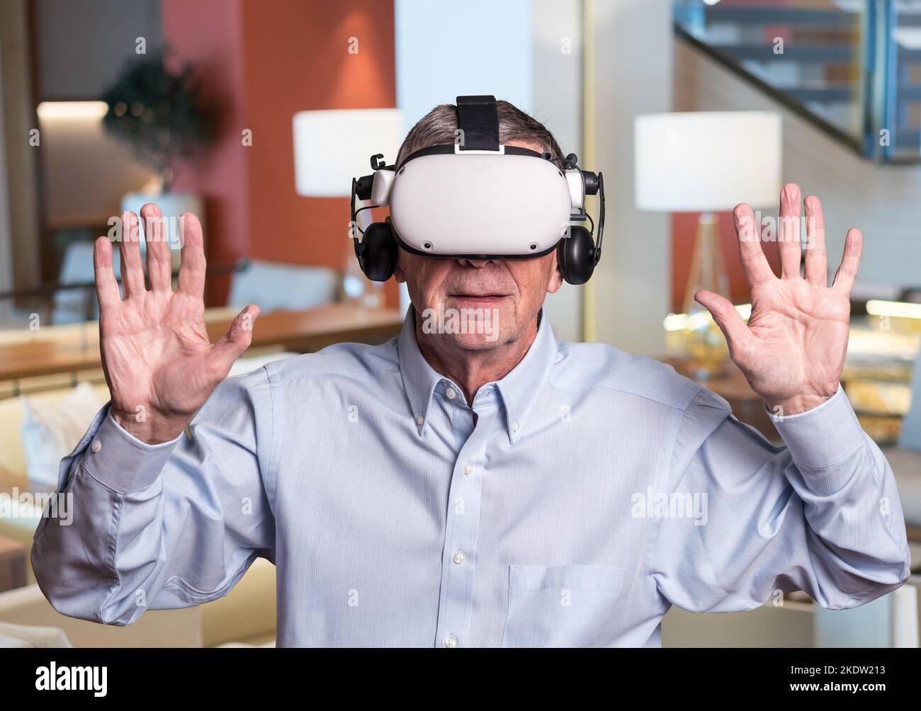 Concept of cybercrime with senior adult being held at ransom while wearing virtual reality headset Stock Photo