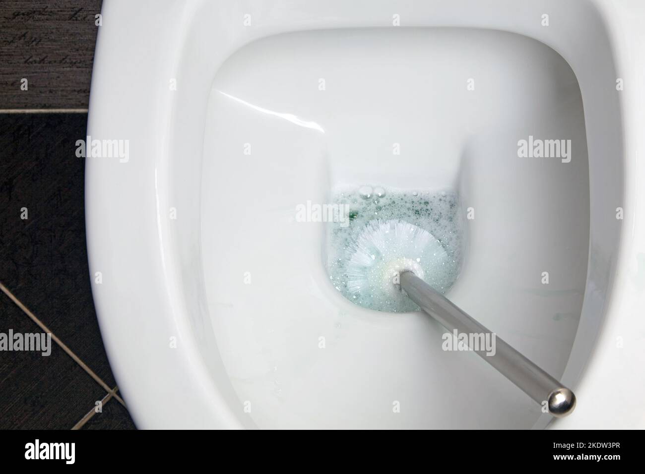 White ceramic toilet bowl and brush for cleaning and disinfection Stock Photo Alamy