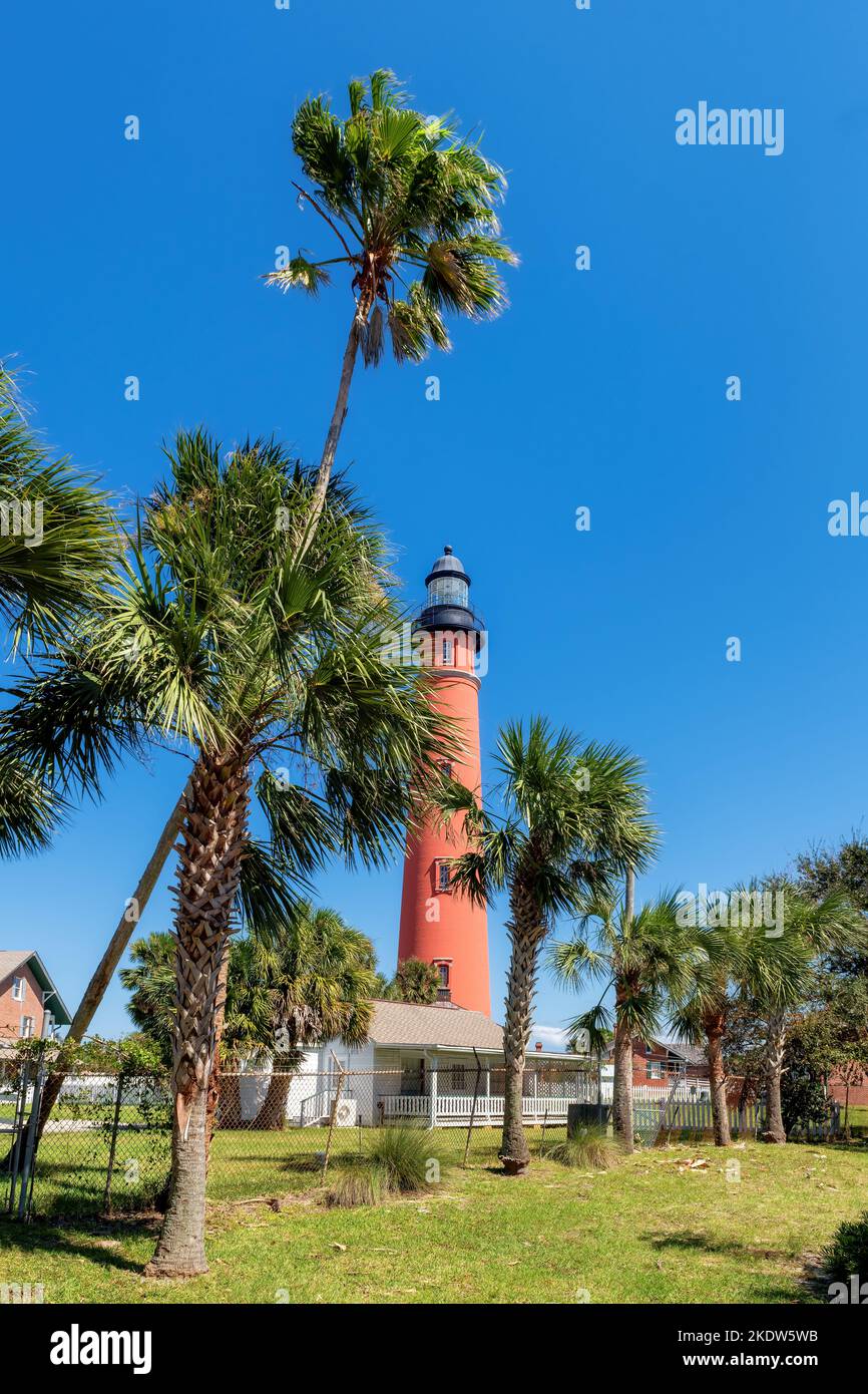 Ponce de Leon Inlet Lighthouse and palm trees around in Daytona Beach