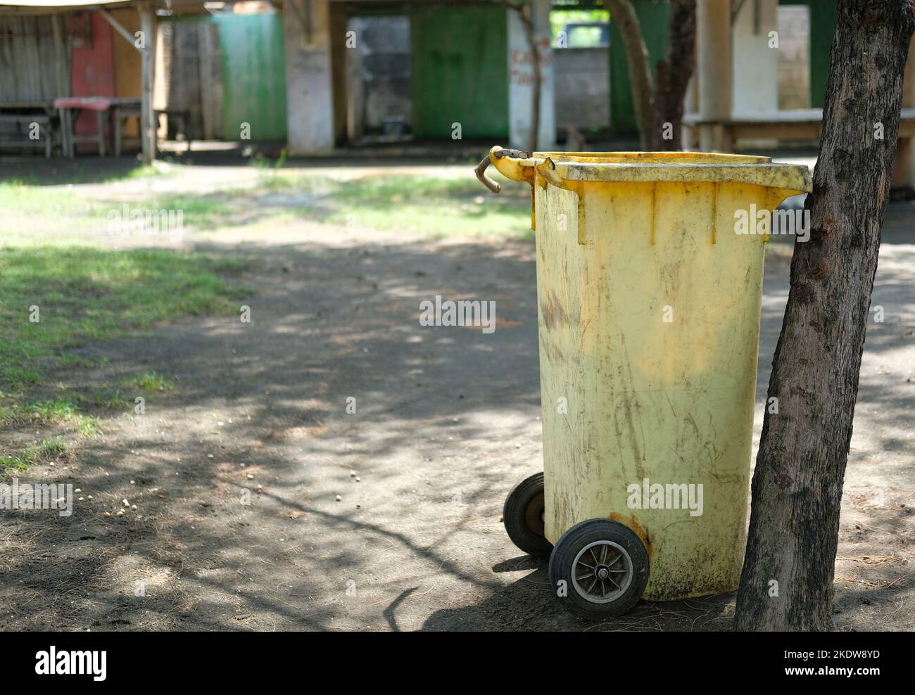 Big yellow trash can in the park. Trash bin Stock Photo Alamy