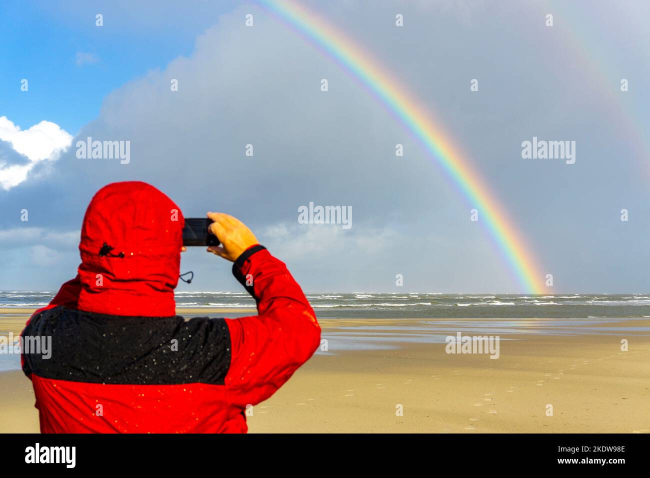 North Sea, Spiekeroog Island, autumn, rainy weather, with sun, rainbow, East Frisian Islands, beach walker take a photo, Lower Saxony, Germany, Stock Photo