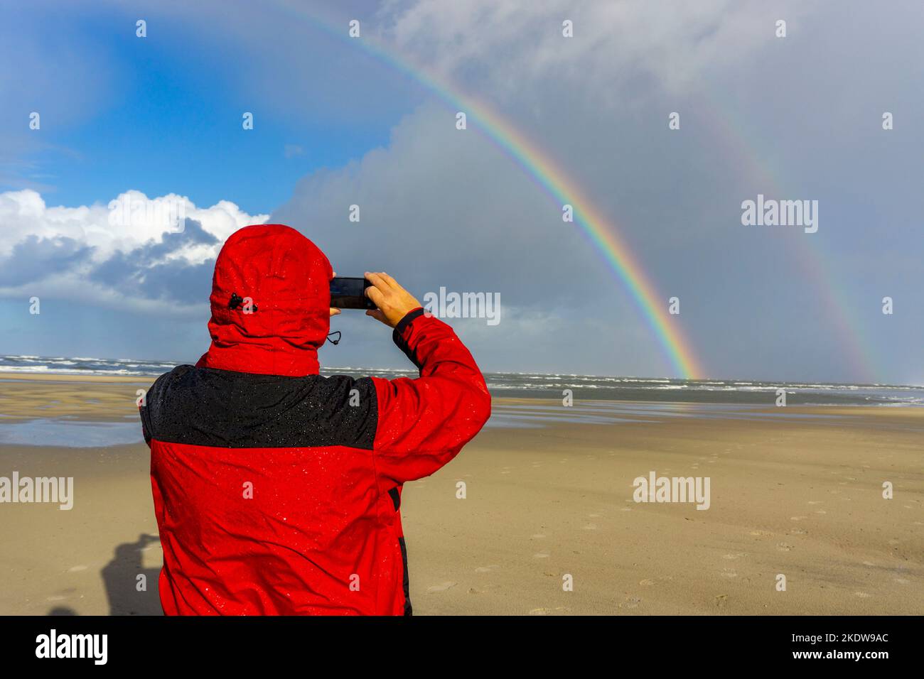 North Sea, Spiekeroog Island, autumn, rainy weather, with sun, rainbow, East Frisian Islands, beach walker take a photo, Lower Saxony, Germany, Stock Photo