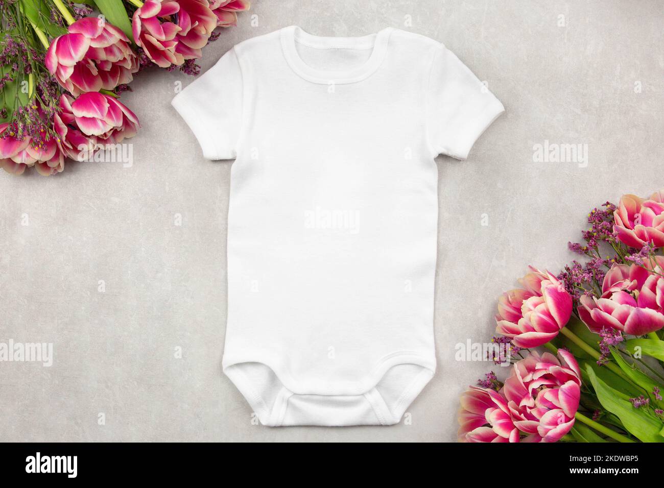 White baby girl or boy bodysuit mockup flat lay with tulip flowers on gray  concrete background. Design onesie template, print presentation mock up  Stock Photo - Alamy