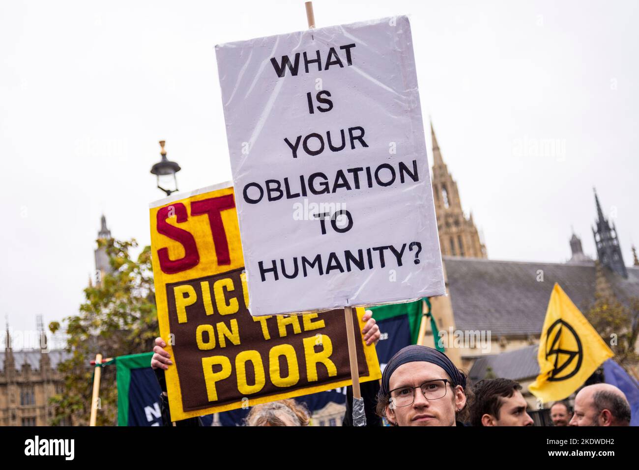 Placard at protest in London against Tory government austerity measures, calling for a general election and higher wages. Obligation to humanity Stock Photo