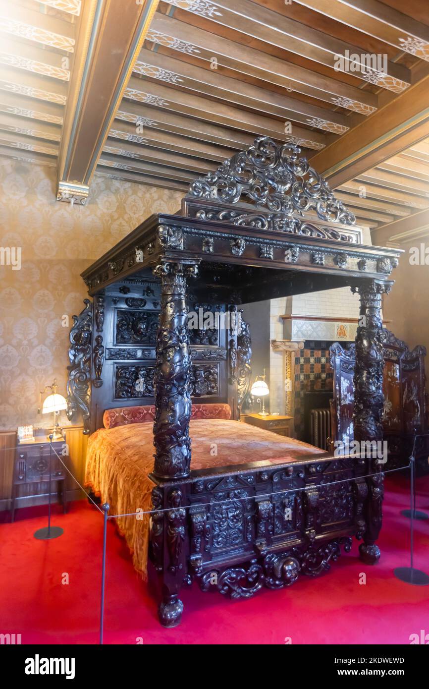 Dark wood bed with carved canopy in bedroom of De Haar Castle Stock Photo -  Alamy, image size:866x1390