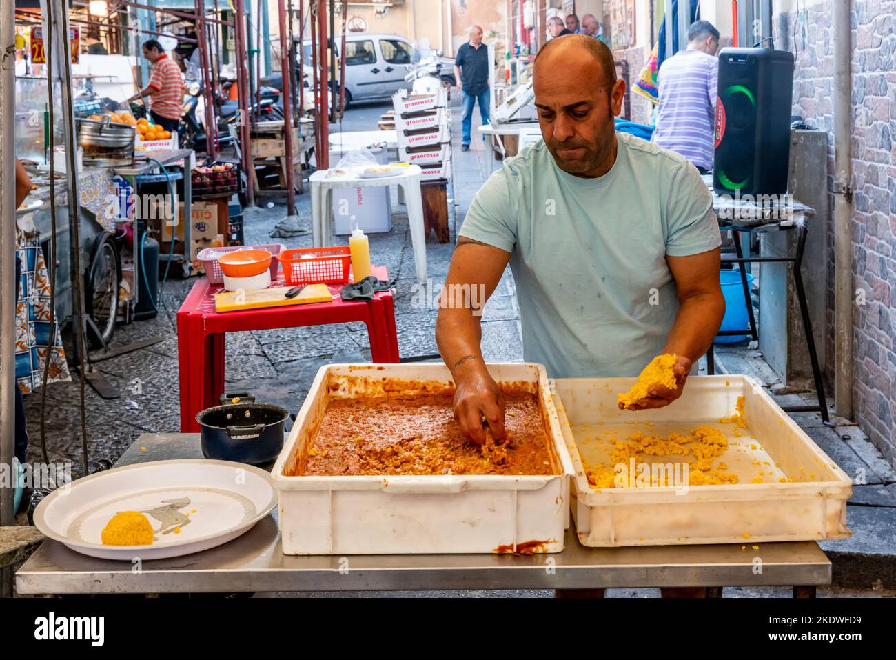 A Local Man Makes The Tradiitional Arancini (Rice Balls) At The Ballaro Street Market, Palermo, Sicily, Italy. Stock Photo