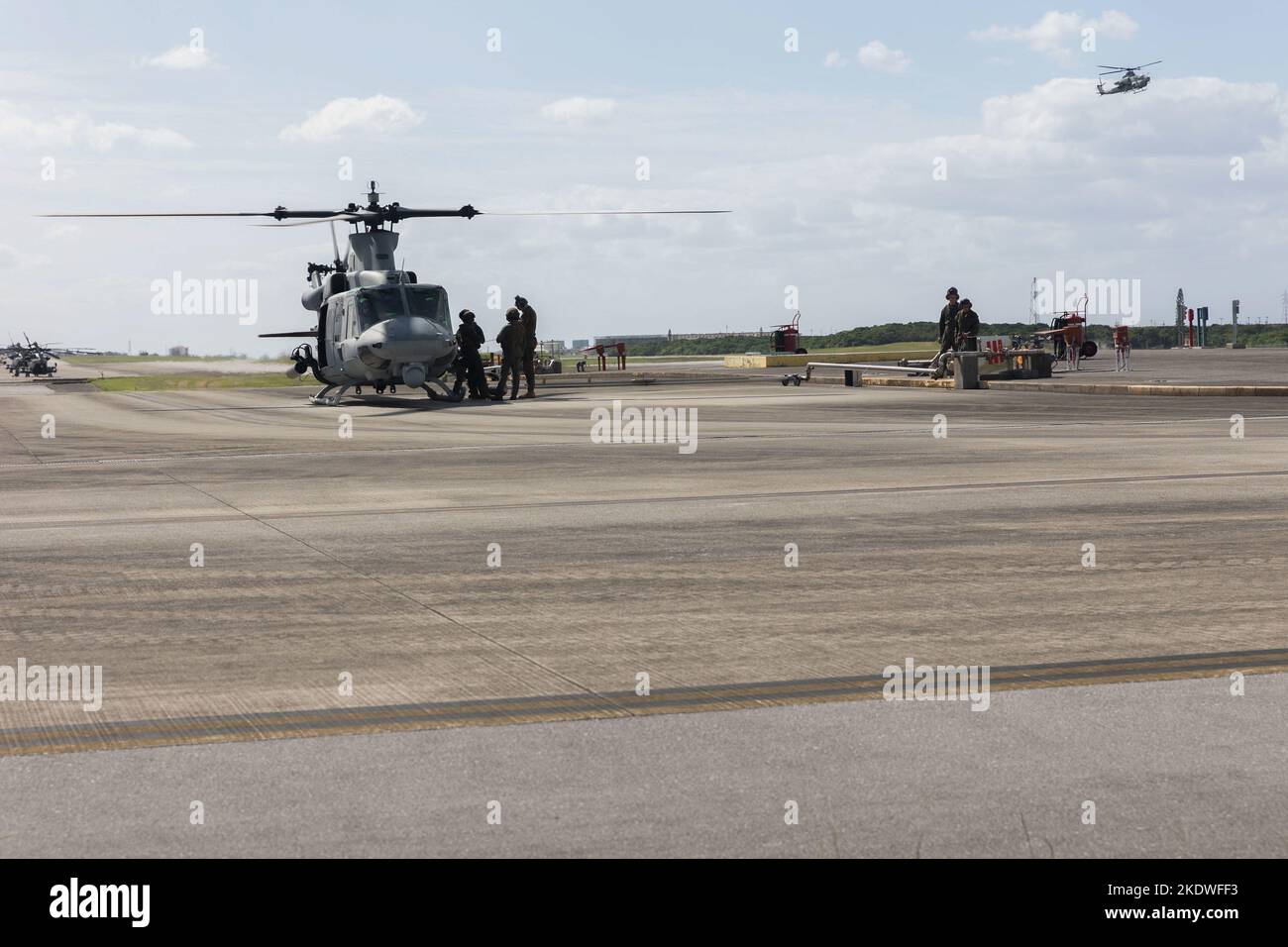 U.S. Marines with Marine Wing Support Squadron (MWSS) 172 standby to refuel a UH-1Y Venom helicopter assigned to Marine Light Attack Helicopter Squadron (HMLA) 469 at Marine Corps Air Station Futenma, Okinawa, Japan, Oct. 25, 2022. MWSS-172 conducted Air Delivered Ground Refueling to train toward rapid-refueling in austere environments for aircraft that cannot be refueled in flight, allowing them to stay in the fight (U.S. Marine Corps photo by Lance Cpl. Emily Weiss) Stock Photo