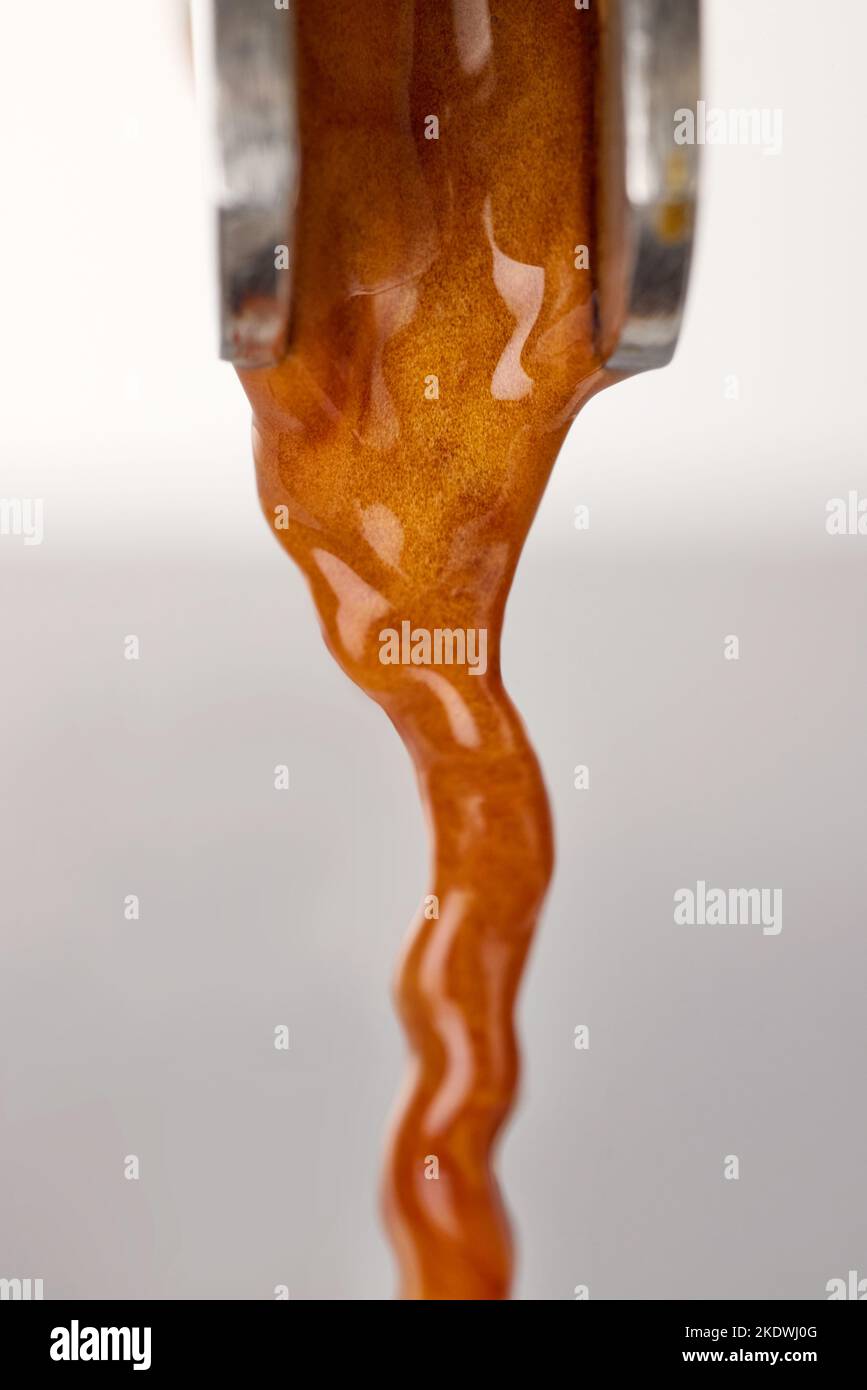 pouring fresh espresso coffee from coffee machine, macro, selective focus Stock Photo