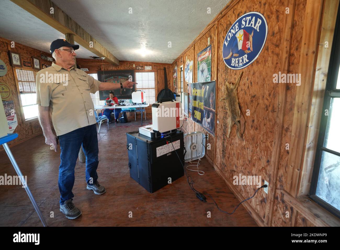 Live Oak County Texas USA, November 8 2022: Election Judge PHILLIP STORM points to a coyote skin on the wall as he waits in the old barbecue joint Ray's outside of Alice, Texas, for voters to arrive during the midterm elections in rural south Texas. The business has been closed about 15 years and is used regularly as a rural polling place. Credit: Bob Daemmrich/Alamy Live News Stock Photo