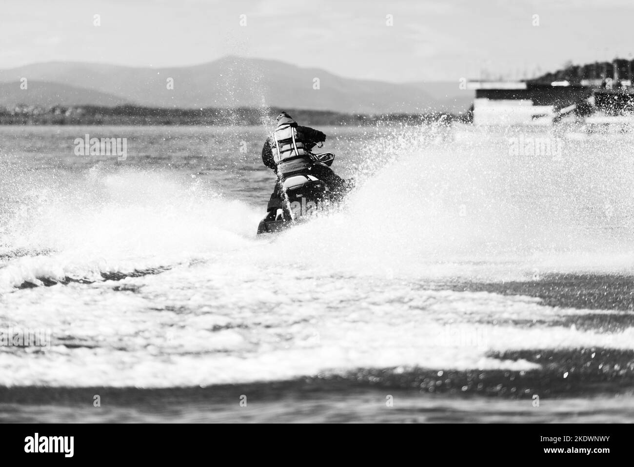 Rescuer Wearing Life Jacket in Protective Uniform on a Jet Ski Observe