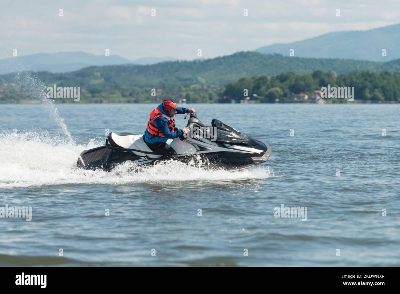 Male Rescuer in Protective Uniform Wearing Life Jacket on a Jet Ski