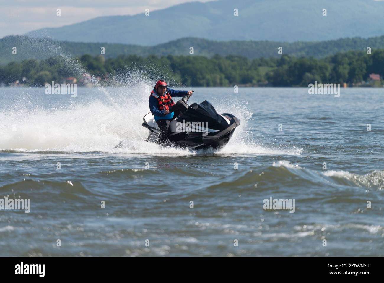Rescuer Wearing Life Jacket in Protective Uniform on a Jet Ski Observe