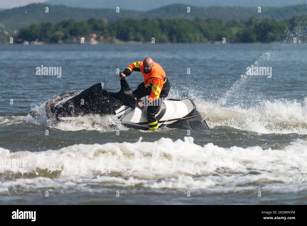 Rescuer Wearing Life Jacket in Protective Uniform on a Jet Ski Observe