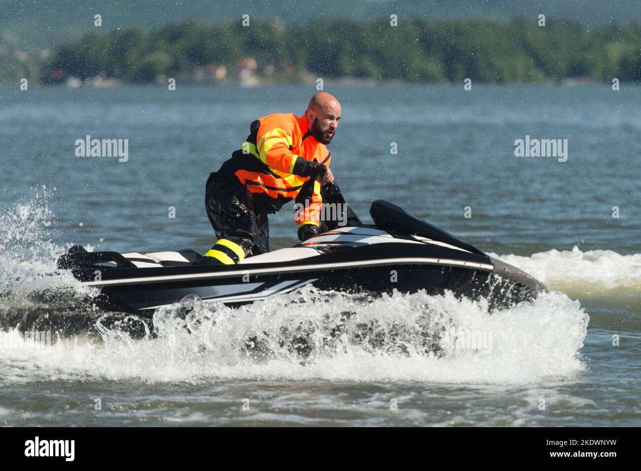 Male Rescuer in Protective Uniform Wearing Life Jacket on a Jet Ski