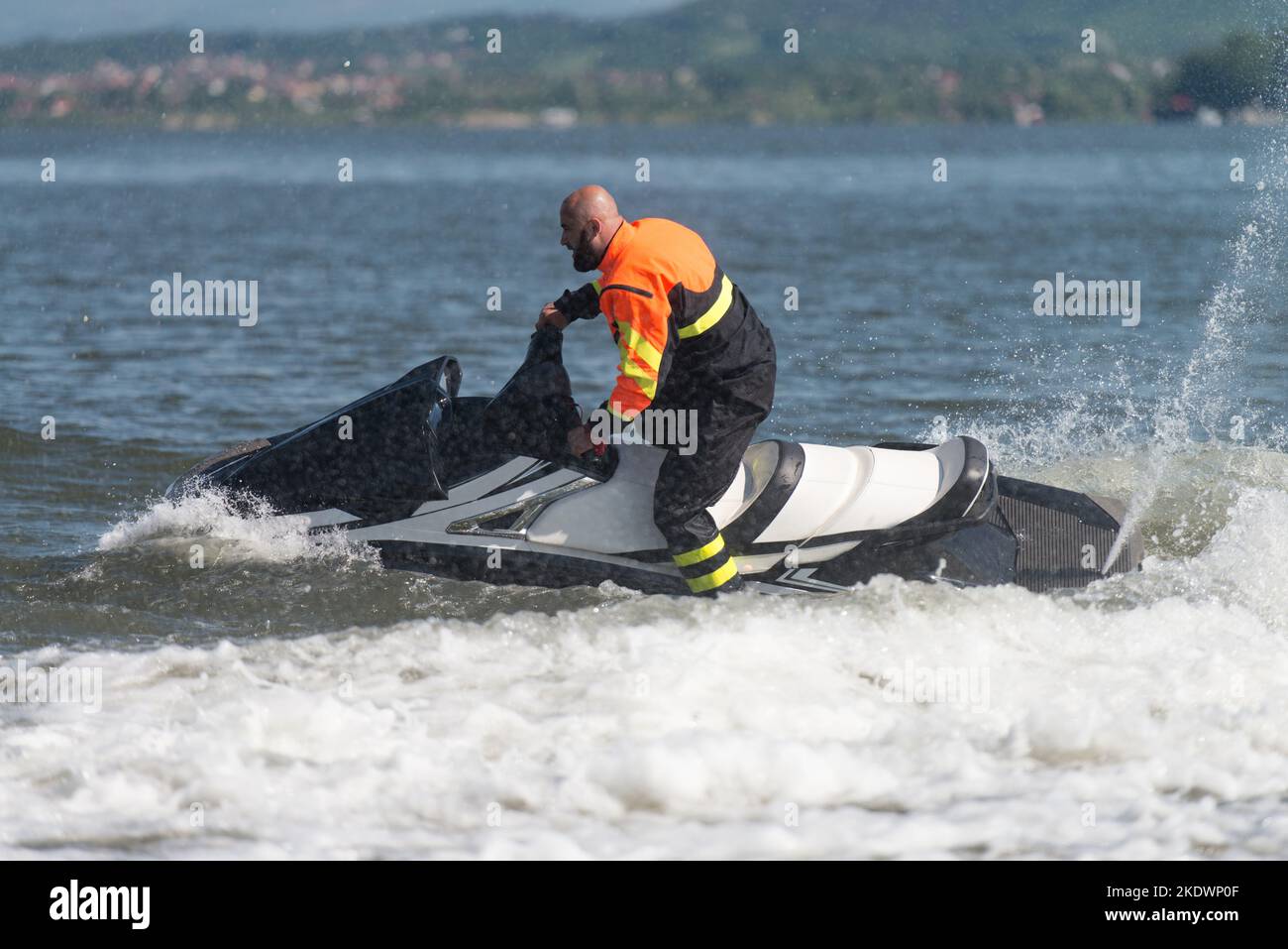 Male Rescuer in Protective Uniform Wearing Life Jacket on a Jet Ski