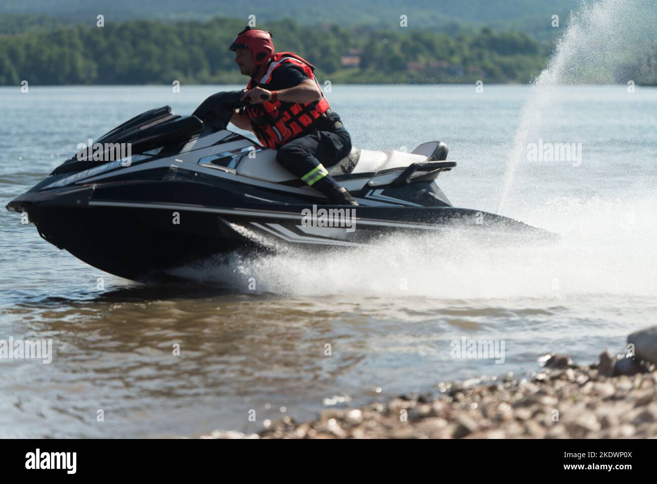 Rescuer Wearing Life Jacket in Protective Uniform on a Jet Ski Observe
