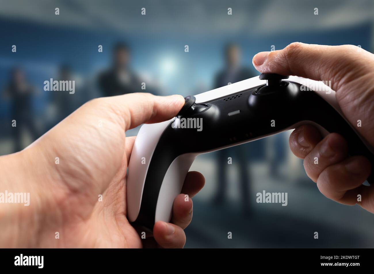Video games. A gamepad in the hands of a gamer against the backdrop of a video game on a large plasma TV screen. Funny online games with friends, priz Stock Photo