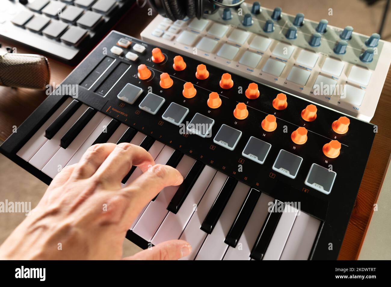 Musician's hand on modern midi keyboard. Closeup. Electronic musical