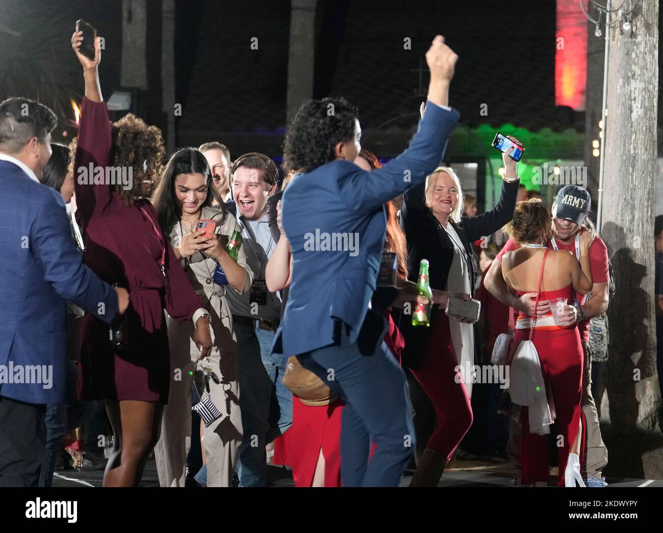McAllen Texas USA, November 8 2022: Excited supporters of Texas Gov. Greg Abbott (not shown) start dancing as they await Abbott's appearance at the governor's election watch party. Abbott won re-election to a third term. ©Bob Daemmrich Stock Photo