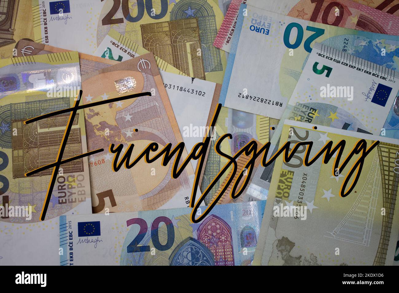 Friendsgiving word with money. Paper currency background with different banknotes. Stock Photo