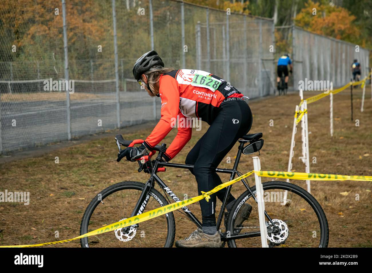 WA22734-00...WASHINGTON - Rider, Tom Kirkandall, following the route tape and making a sharp turn at the Magnuson Park  MFG cyclocross race in Seattle Stock Photo