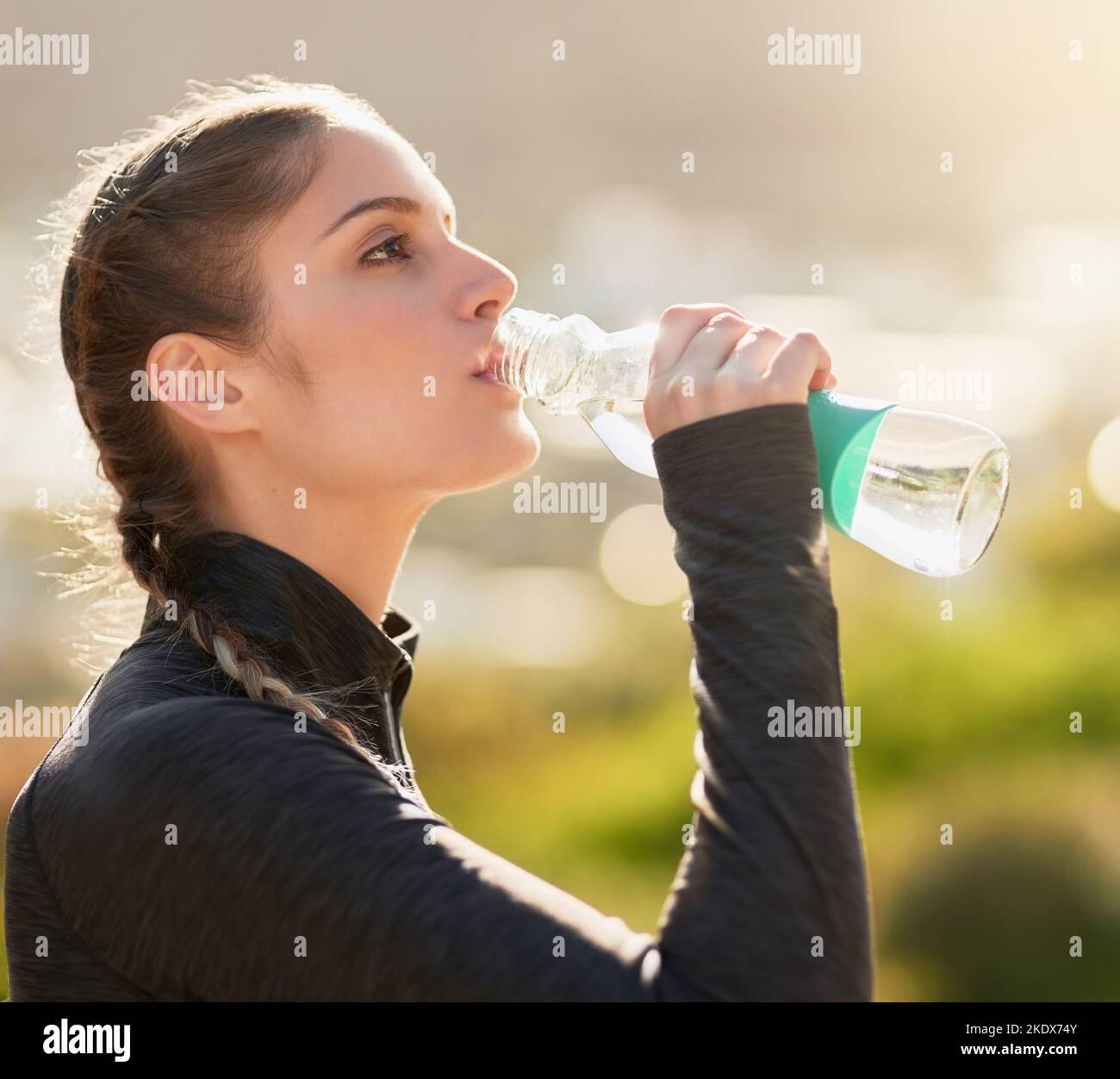 Staying hydrated. an attractive young woman drinking water during her