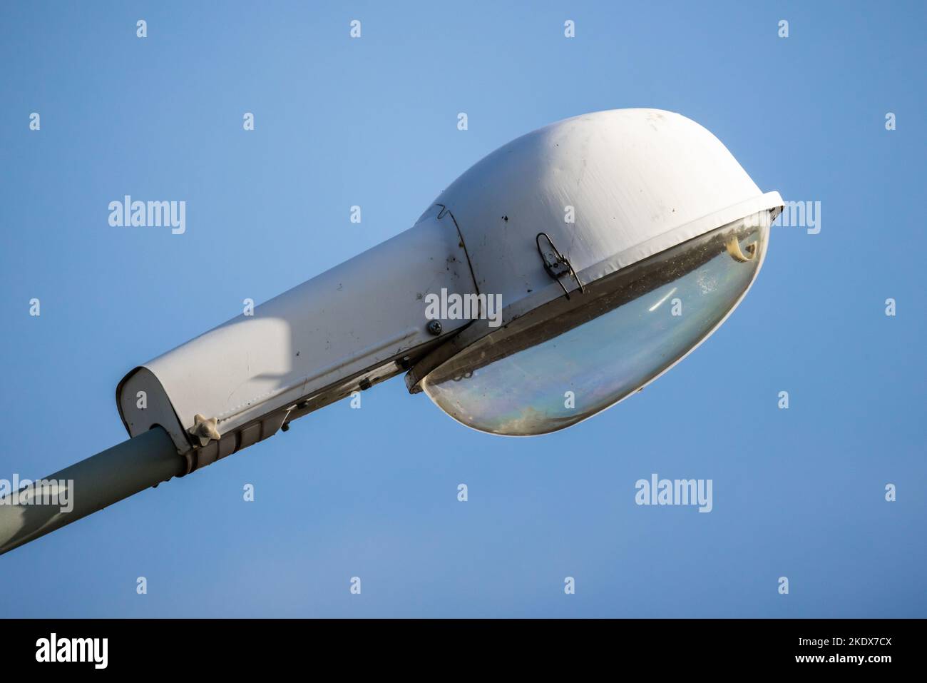 Urban street lamp is under blue sky on a daytime, close up photo Stock Photo