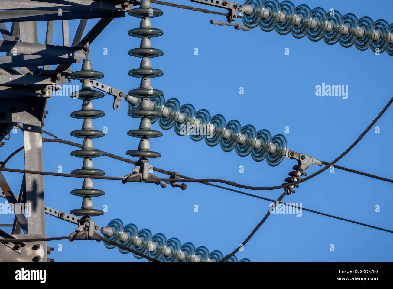 Insulators used in overhead power lines are under blue sky on a daytime
